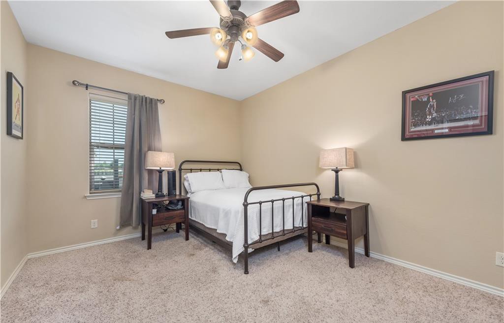 3201 Cain Road College Station, TX 77845 - Photo 3 of 8 Bedroom with light colored carpet and a ceiling fan