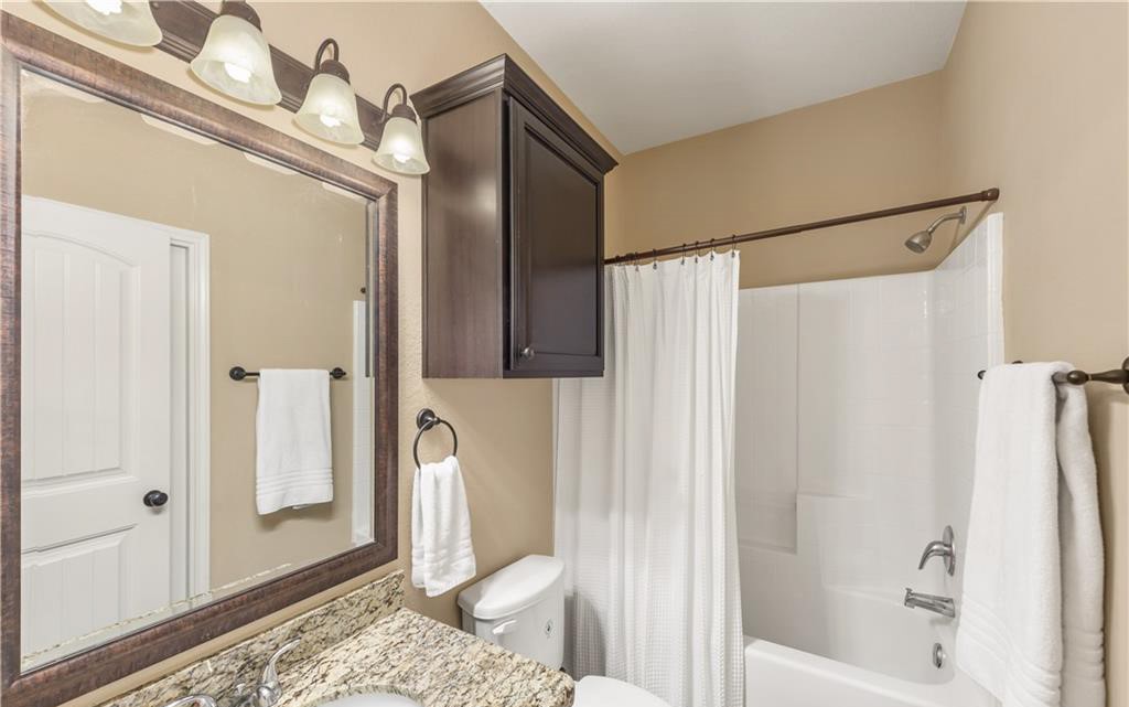3201 Cain Road College Station, TX 77845 - Photo 4 of 8 Bathroom featuring shower / tub combo with curtain and vanity
