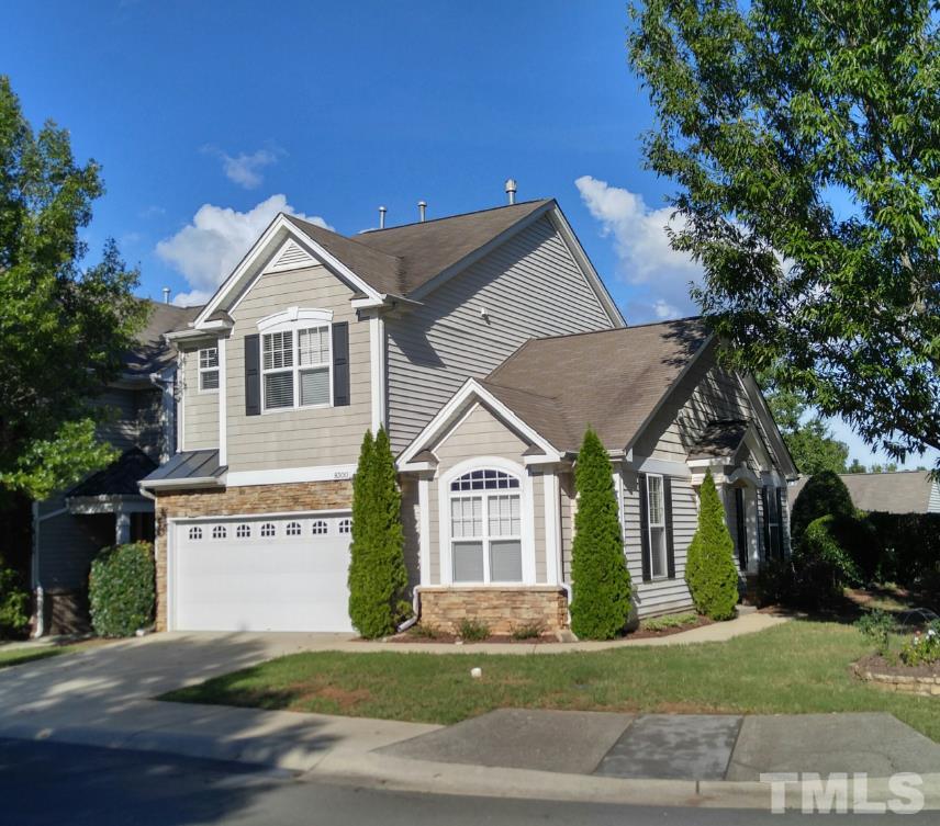 8300 Chimneycap Drive Raleigh, NC 27613 - Photo 1 of 3 a view of a white house next to a yard with big trees