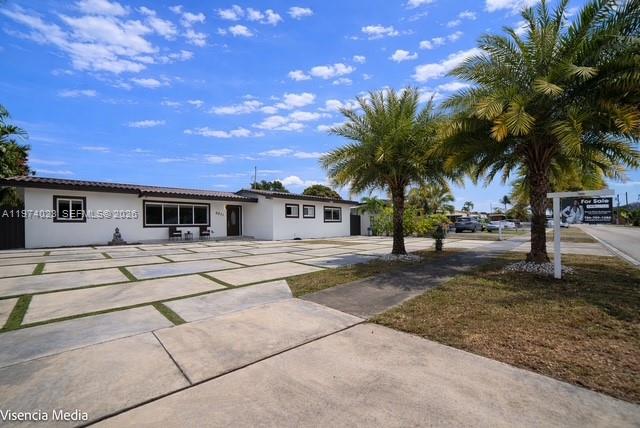 6271 Northwest 110th Street Hialeah, FL 33012 - Photo 13 of 53 a front view of a house with a yard and palm tree