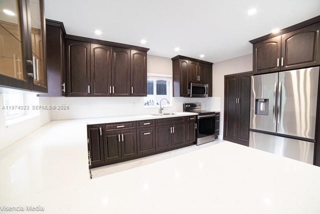 6271 Northwest 110th Street Hialeah, FL 33012 - Photo 2 of 53 a kitchen with stainless steel appliances a refrigerator and a sink