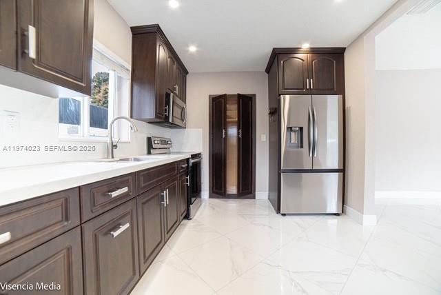 6271 Northwest 110th Street Hialeah, FL 33012 - Photo 49 of 53 a kitchen with stainless steel appliances a refrigerator and a sink