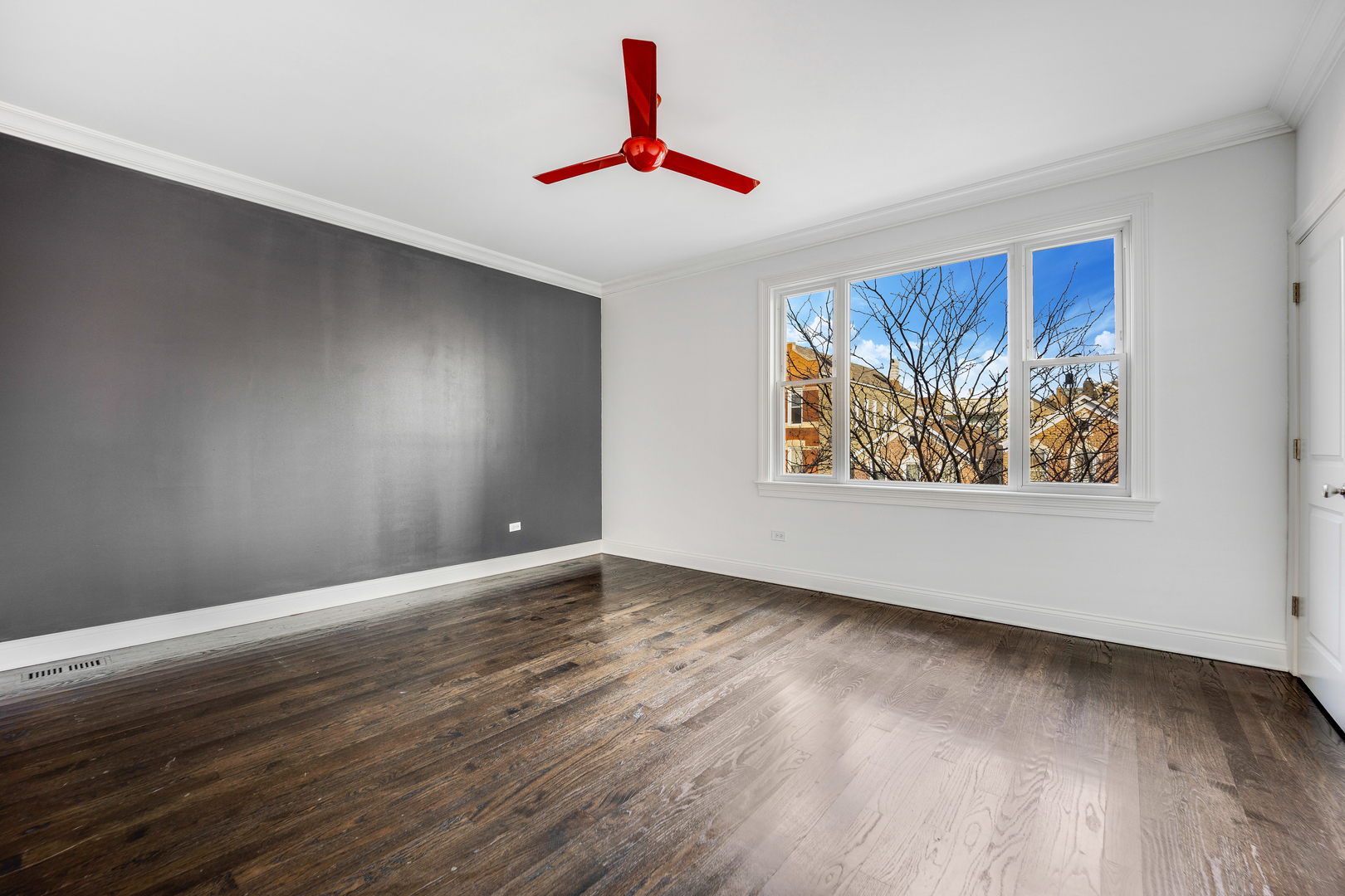 1317 West 18th Place, Unit 1F Chicago, IL 60608 - Photo 11 of 26 a view of an empty room with wooden floor and a window