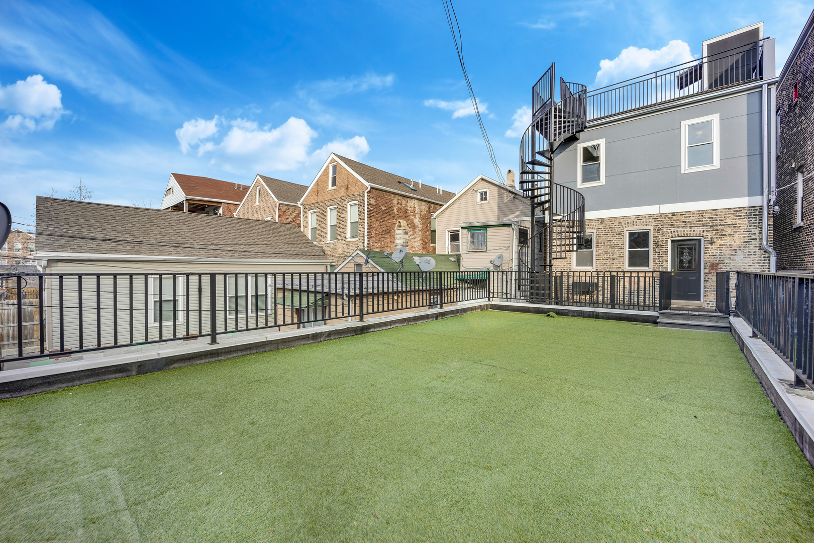 1317 West 18th Place, Unit 1F Chicago, IL 60608 - Photo 20 of 26 a view of a house with a yard and deck