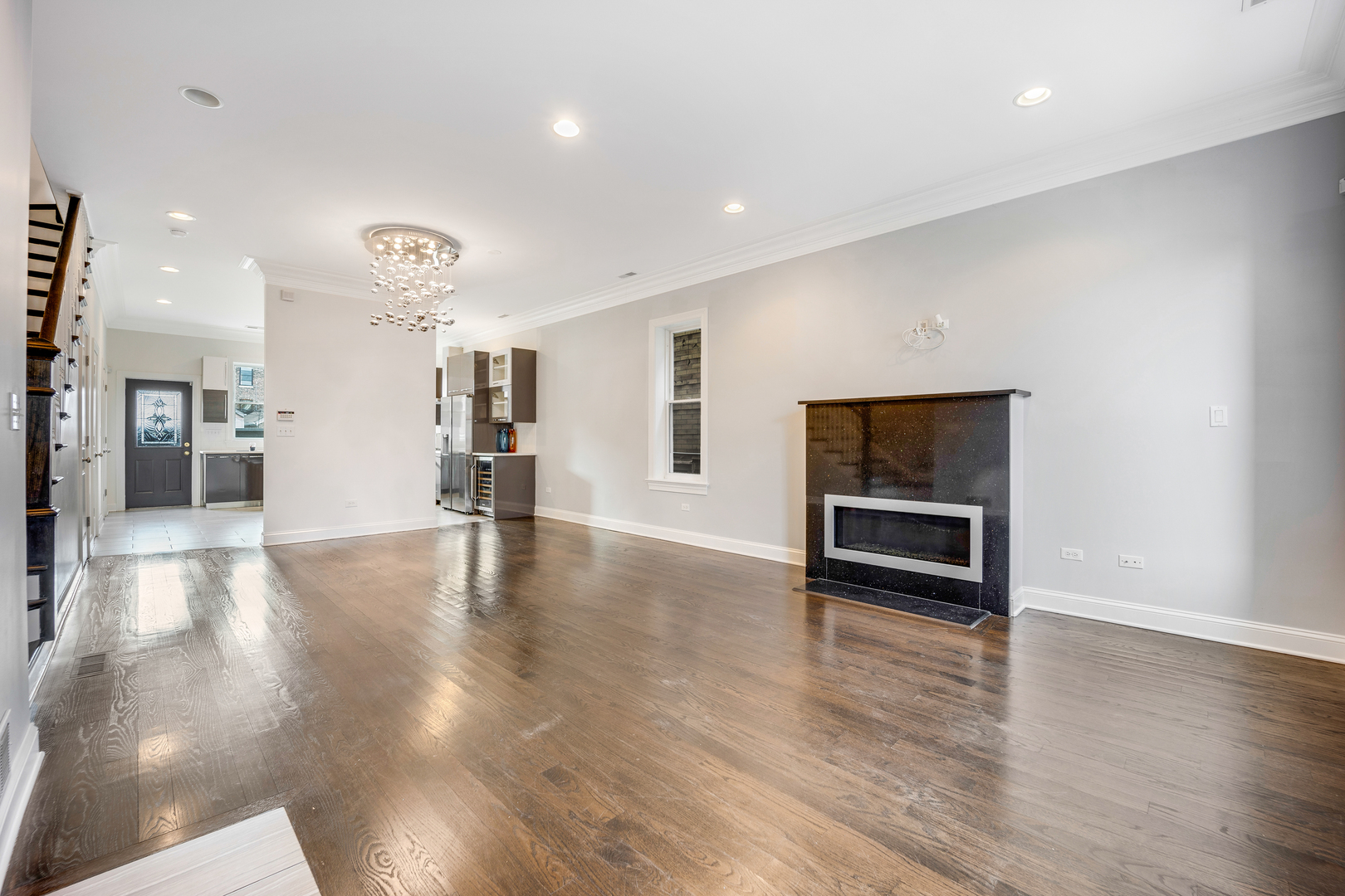 1317 West 18th Place, Unit 1F Chicago, IL 60608 - Photo 4 of 26 an empty room with wooden floor and kitchen view