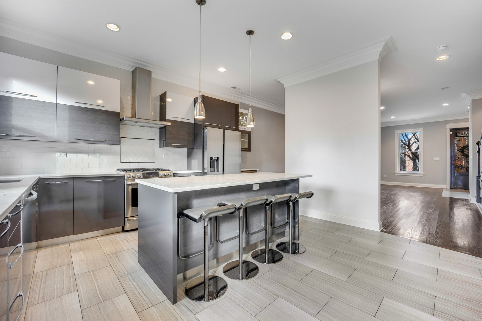 1317 West 18th Place, Unit 1F Chicago, IL 60608 - Photo 6 of 26 a kitchen with stainless steel appliances kitchen island granite countertop a sink and a refrigerator
