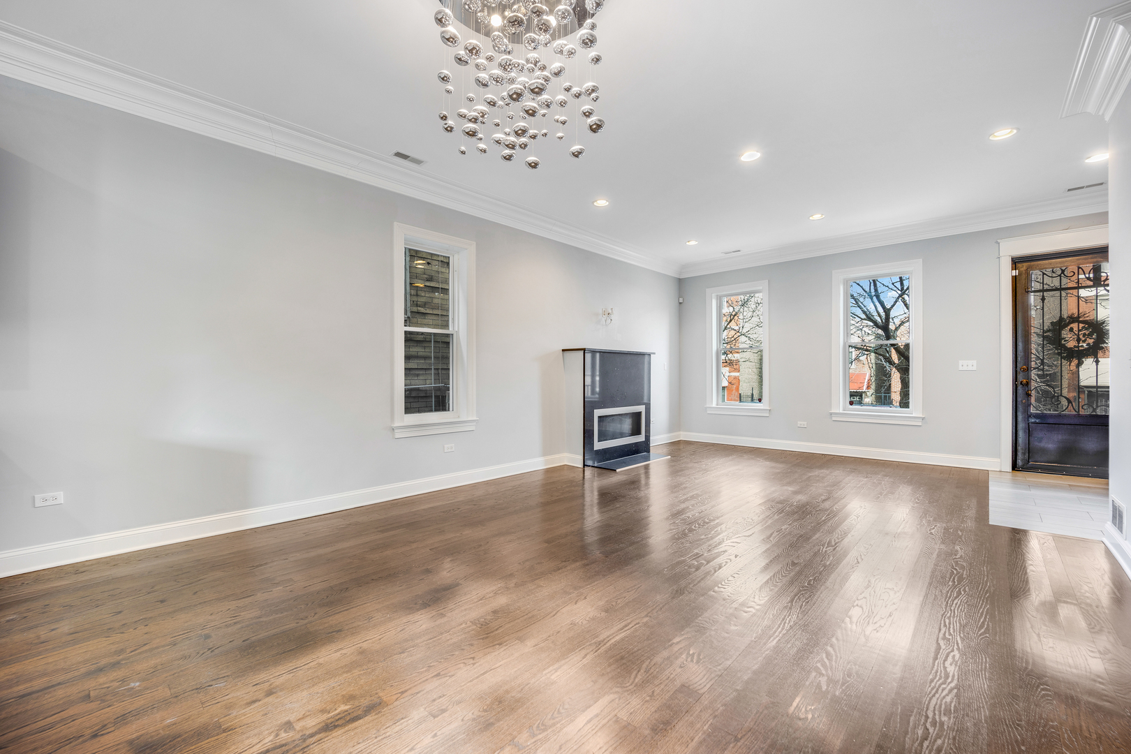 1317 West 18th Place, Unit 1F Chicago, IL 60608 - Photo 8 of 26 wooden floor in an empty room with a window