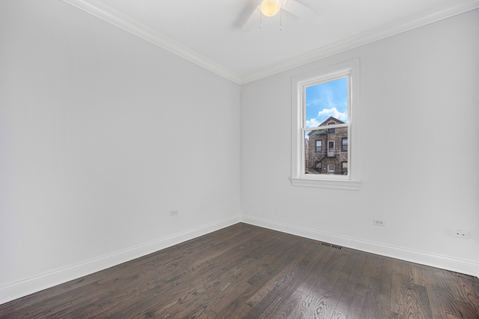 1317 West 18th Place, Unit 1F Chicago, IL 60608 - Photo 10 of 26 a view of a room that has wooden floor and window