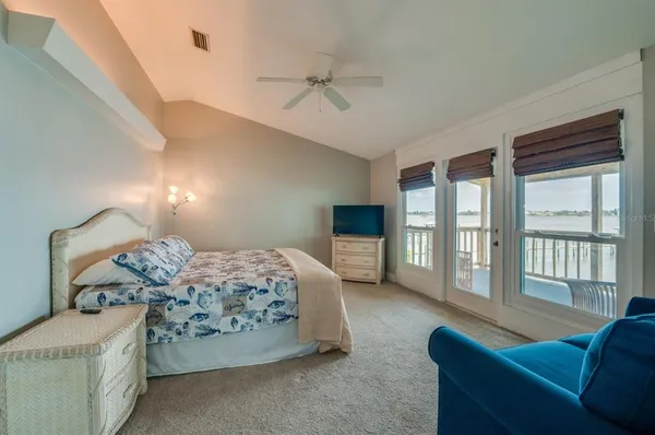 a bedroom with furniture and a large window