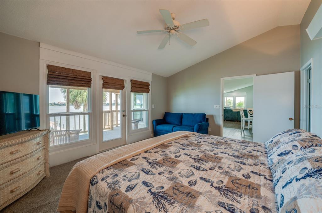 1633 Riverside Drive Daytona Beach, FL 32117 - Photo 17 of 26 a bedroom with a large bed and a chandelier fan