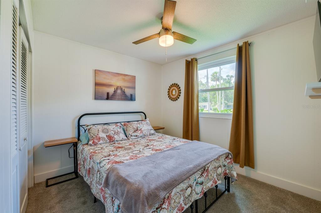 1633 Riverside Drive Daytona Beach, FL 32117 - Photo 21 of 26 a bedroom with a bed and a window