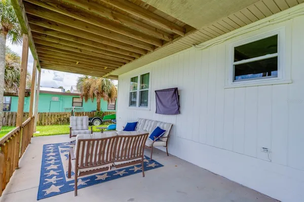 a backyard of a house with table and chairs