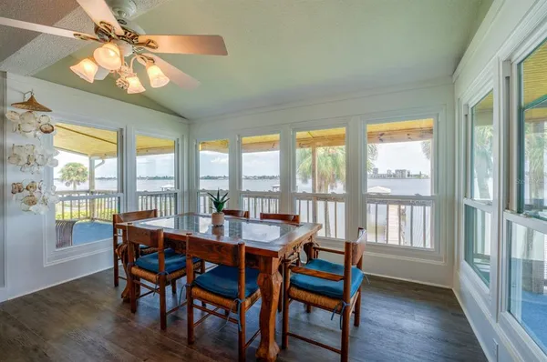 a dining room with furniture a chandelier and wooden floor