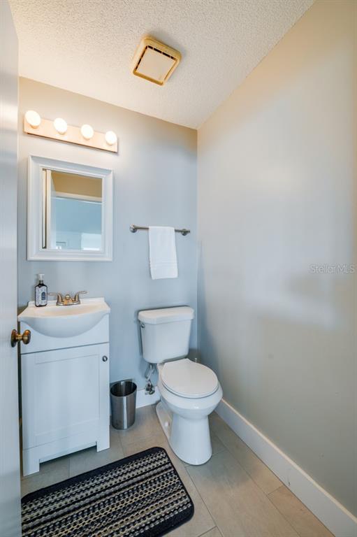 1633 Riverside Drive Daytona Beach, FL 32117 - Photo 10 of 26 a bathroom with a toilet a sink and a mirror
