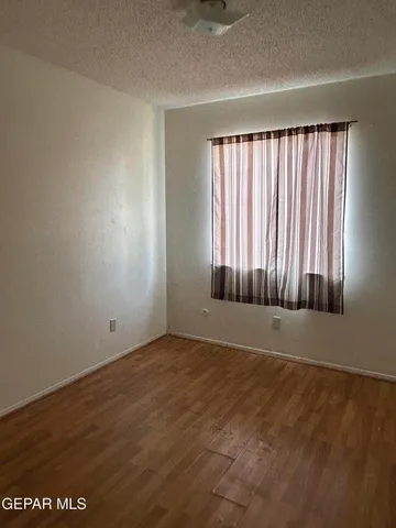 a view of a refrigerator in kitchen and a sink