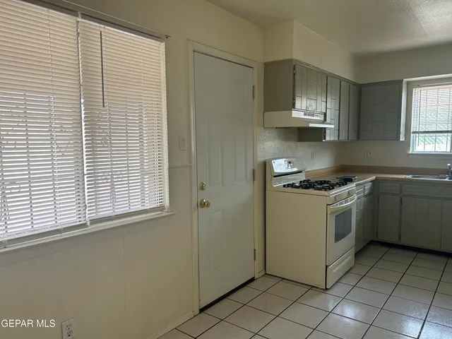 a kitchen with a cabinets and white appliances