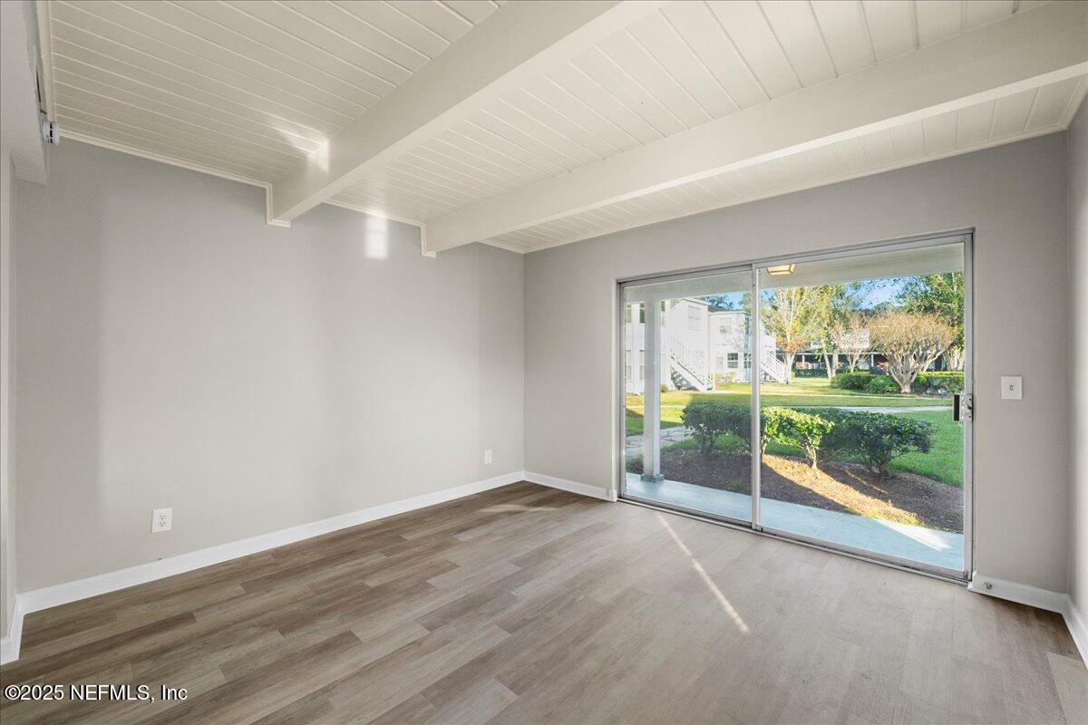 4358 Timuquana Road, Unit 208 Jacksonville, FL 32210 - Photo 12 of 28 an empty room with wooden floor and garden