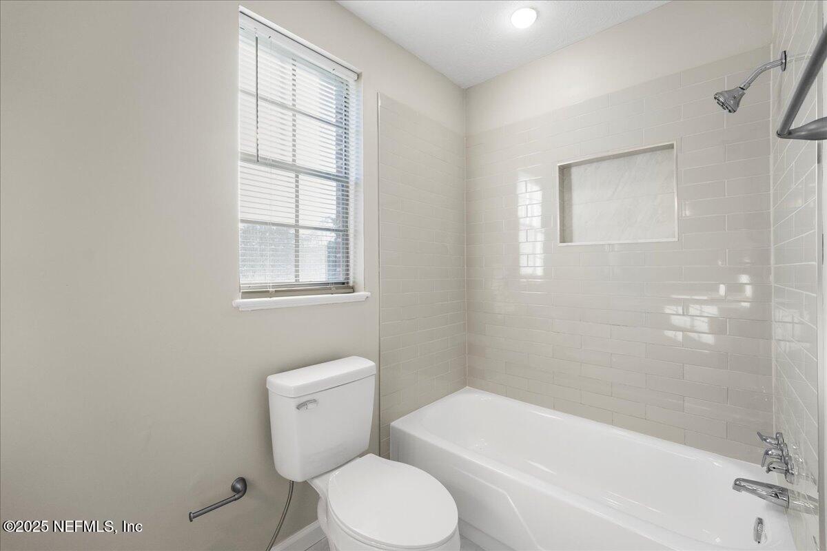 4358 Timuquana Road, Unit 208 Jacksonville, FL 32210 - Photo 18 of 28 a white toilet sitting next to a bath tub