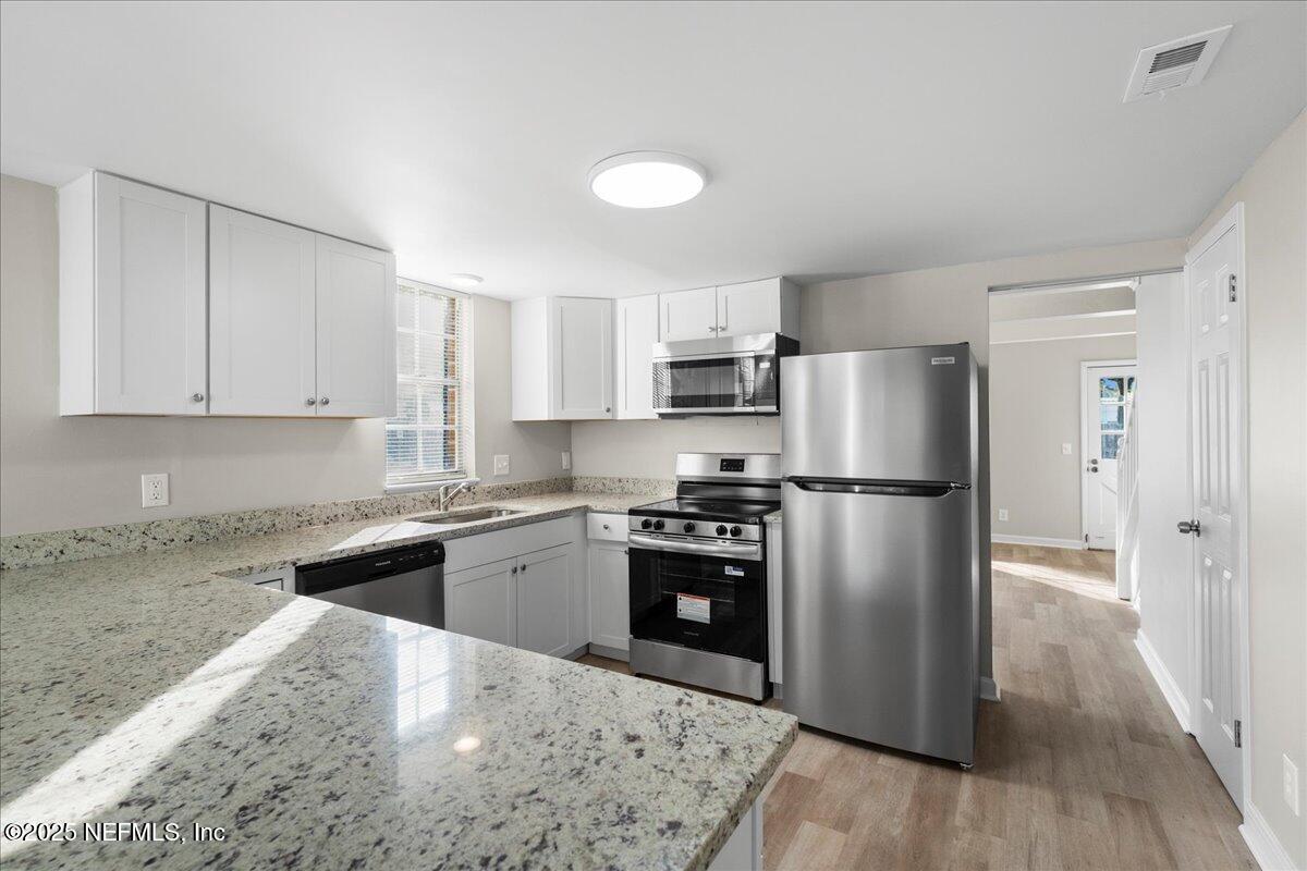 4358 Timuquana Road, Unit 208 Jacksonville, FL 32210 - Photo 2 of 28 a kitchen with a refrigerator sink and cabinets