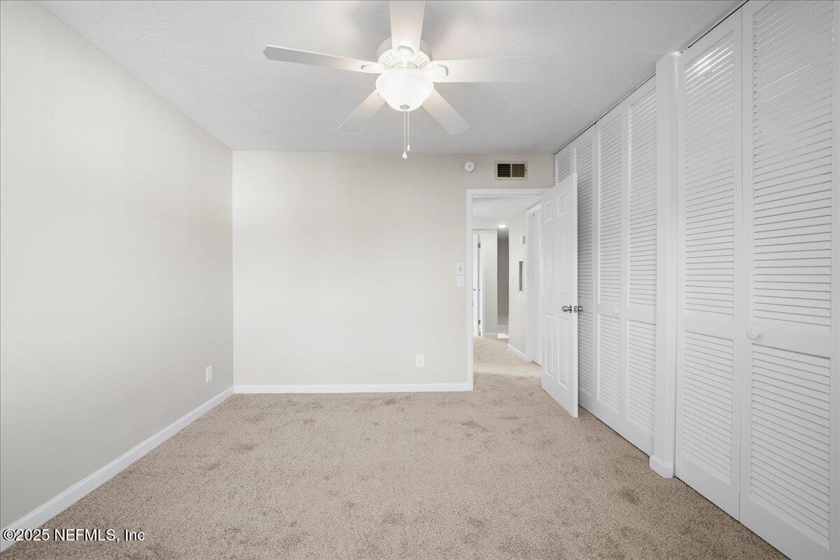 4358 Timuquana Road, Unit 208 Jacksonville, FL 32210 - Photo 21 of 28 an empty room with a ceiling fan and a window