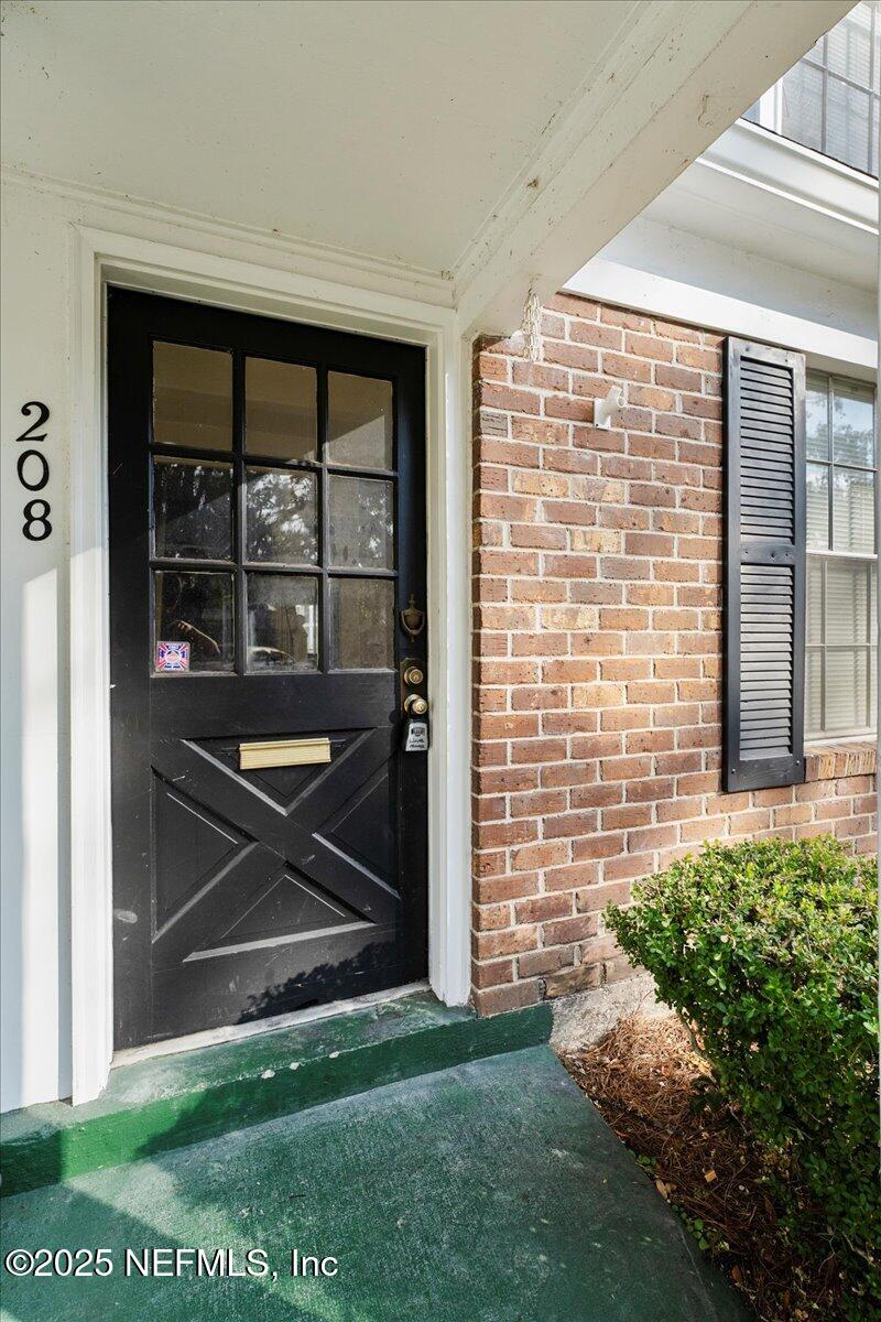 4358 Timuquana Road, Unit 208 Jacksonville, FL 32210 - Photo 4 of 28 a front view of a house with a yard