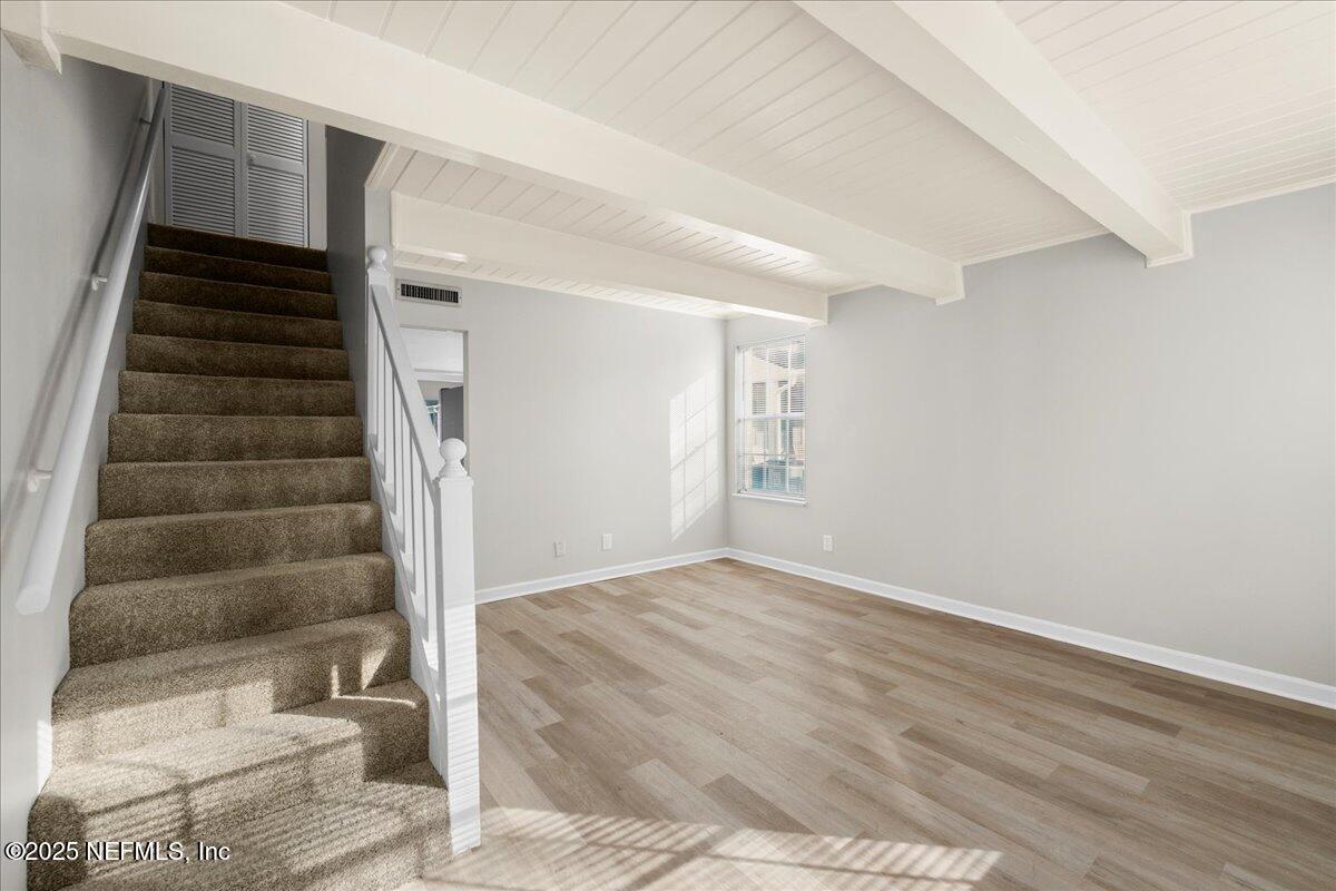 4358 Timuquana Road, Unit 208 Jacksonville, FL 32210 - Photo 5 of 28 a view of an empty room with wooden floor and stairs