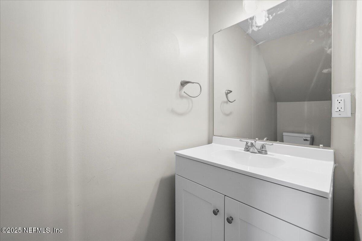 4358 Timuquana Road, Unit 208 Jacksonville, FL 32210 - Photo 6 of 28 a bathroom with a sink mirror and vanity