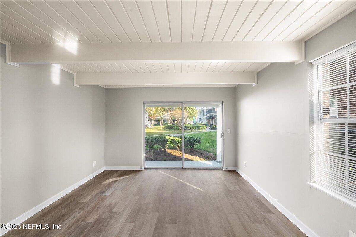 4358 Timuquana Road, Unit 208 Jacksonville, FL 32210 - Photo 7 of 28 wooden floor in an empty room with a window