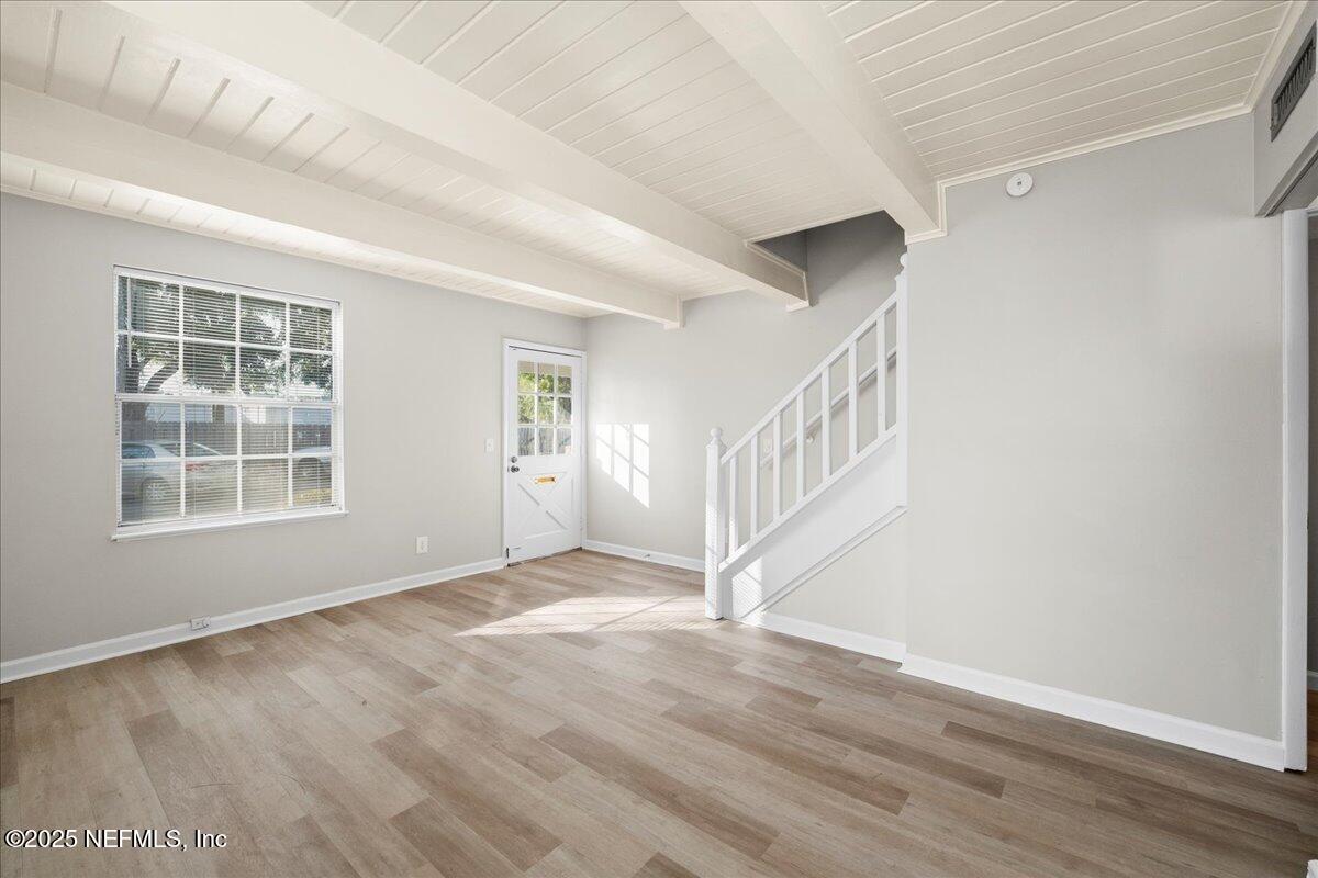 4358 Timuquana Road, Unit 208 Jacksonville, FL 32210 - Photo 8 of 28 a view of an empty room with wooden floor and a window