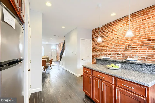 a view of a kitchen with a sink and a wooden floor