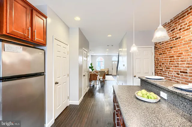 a view of a kitchen with dining area and wooden floor