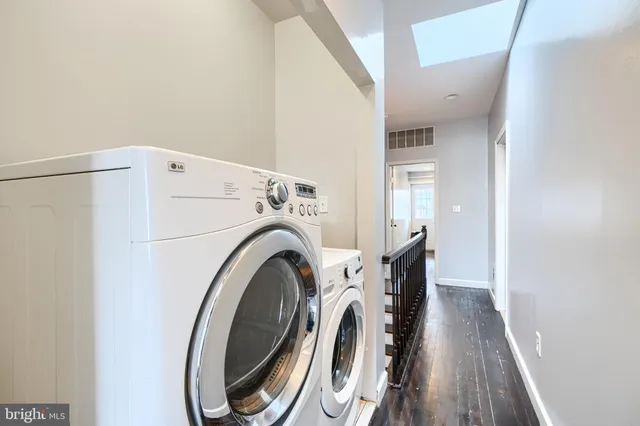 a view of a hallway with washer and dryer