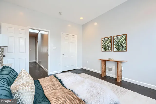 a bedroom with a bed and a painting on the wall