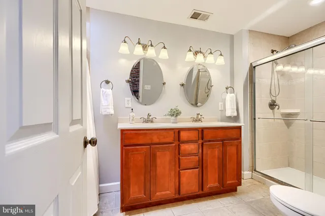 a bathroom with double vanity sink and mirror