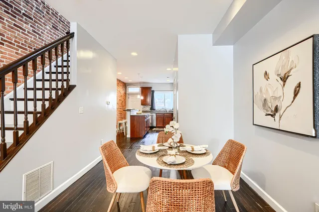 a dining room with furniture and wooden floor