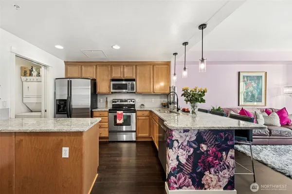 a kitchen with stainless steel appliances granite countertop a sink stove and refrigerator