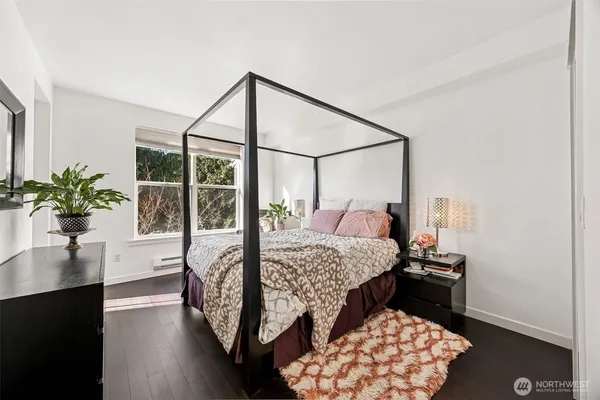 a bedroom with bed and wooden floor