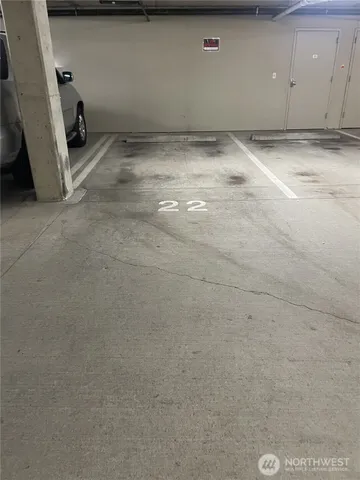 a view of a street with potted plants and large trees
