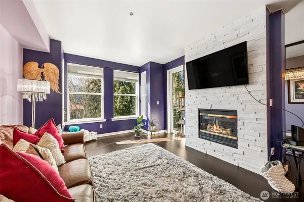 a living room with furniture fireplace and flat screen tv