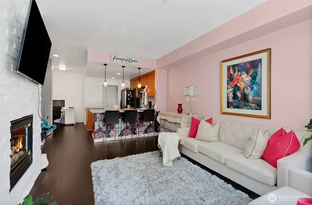 a living room with furniture fireplace and flat screen tv