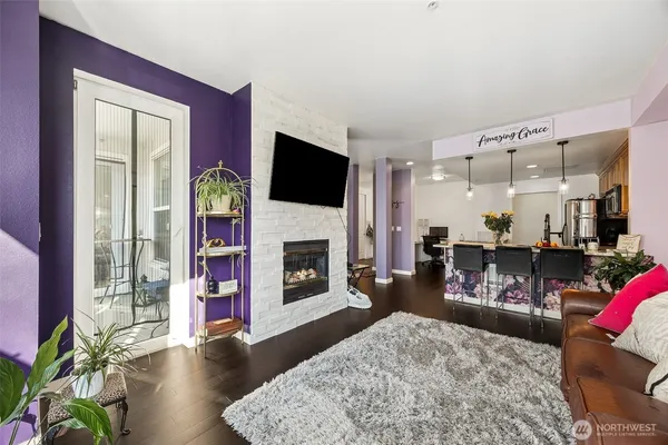 a living room with furniture a fireplace and a flat screen tv