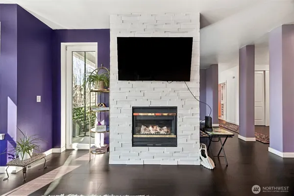 a living room with a fireplace a flat screen tv and a fireplace