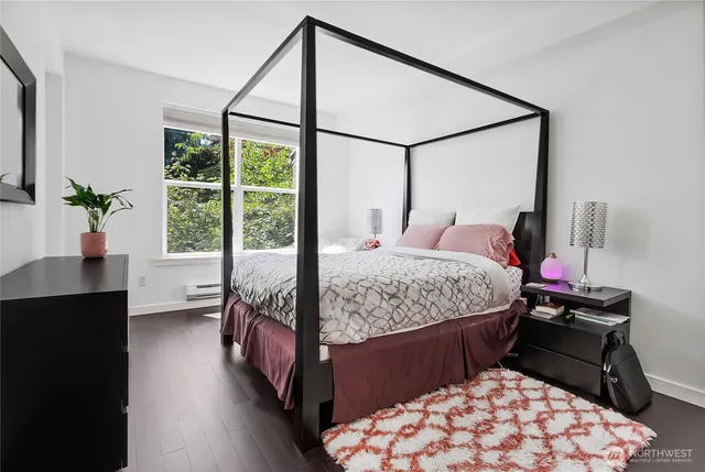 a bedroom with a bed window and table