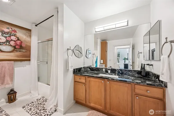 a bathroom with a granite countertop sink and a mirror