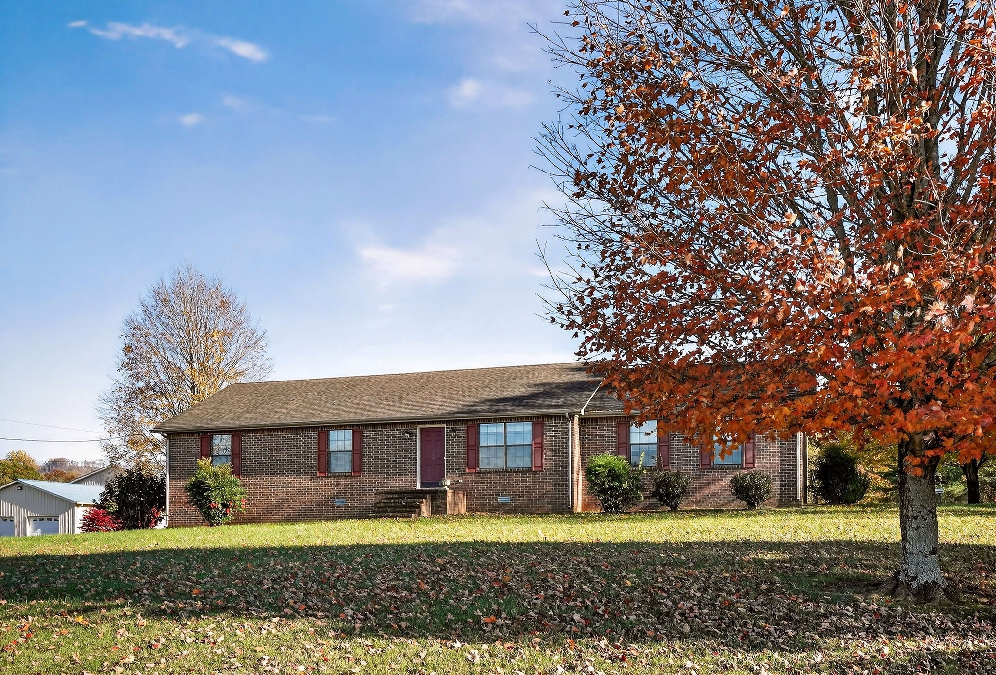 4143 Viola Road McMinnville, TN 37110 - Photo 2 of 27 a view of a big house with a big yard and large trees