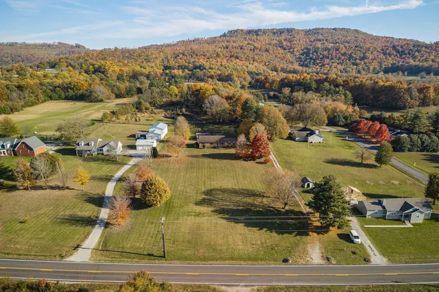 a view of a house with a yard and mountain view