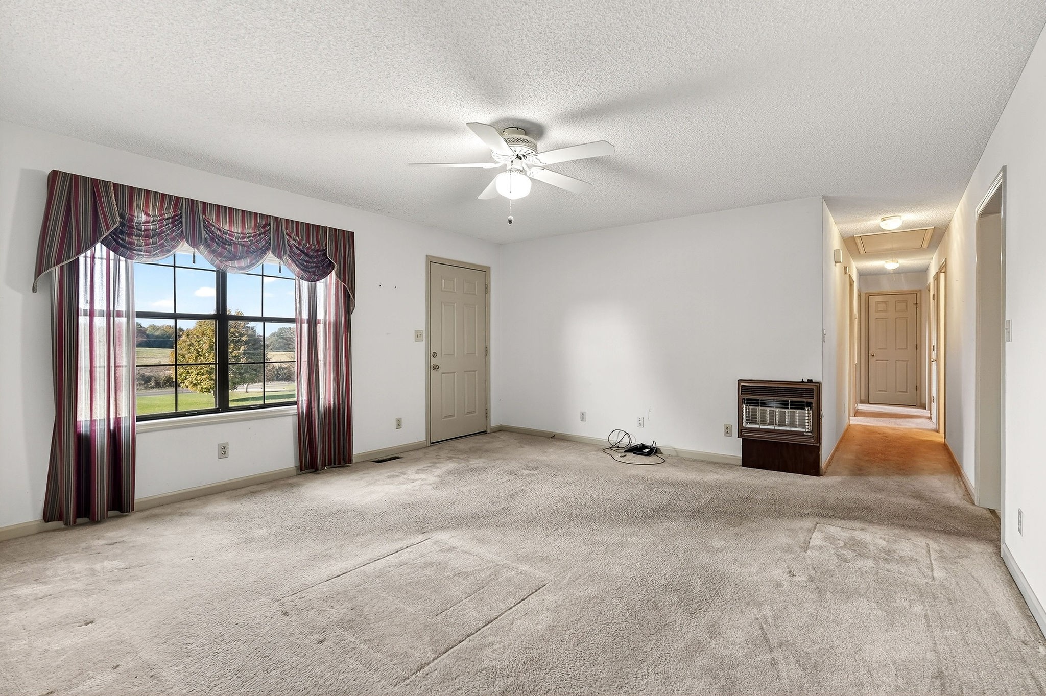 4143 Viola Road McMinnville, TN 37110 - Photo 5 of 27 a view of empty room with a fireplace and window