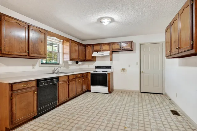 a kitchen with stainless steel appliances granite countertop a refrigerator and sink