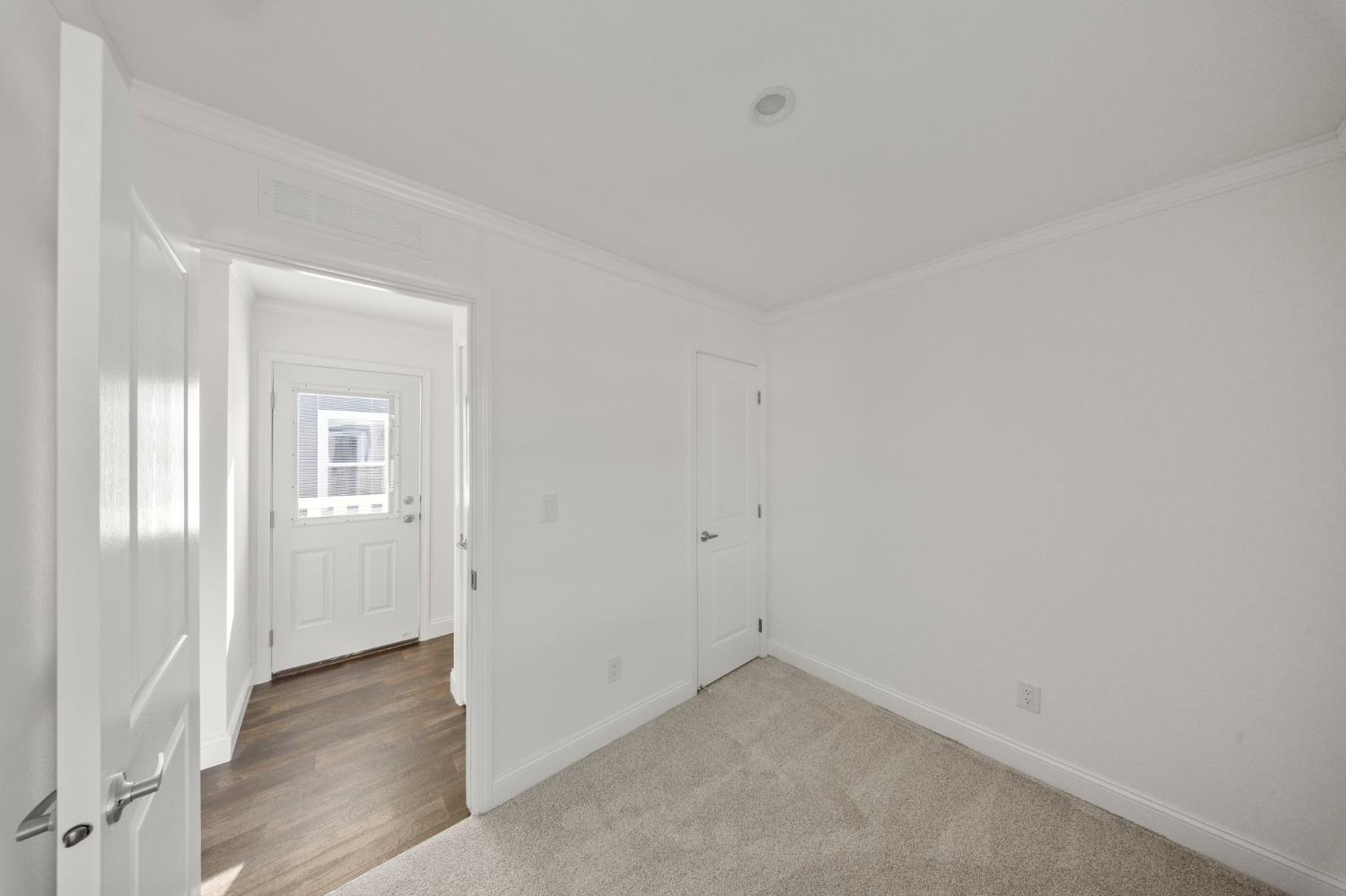 2030 East Grayson Road, Unit 44 Ceres, CA 95307 - Photo 11 of 20 an empty room with wooden floor and windows