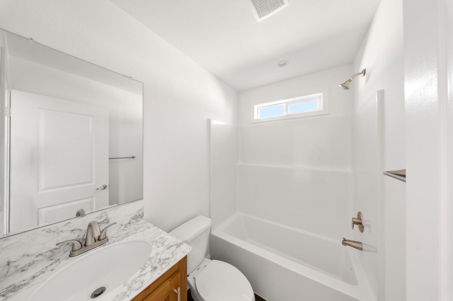 2030 East Grayson Road, Unit 44 Ceres, CA 95307 - Photo 13 of 20 a bathroom with a granite countertop sink toilet and shower